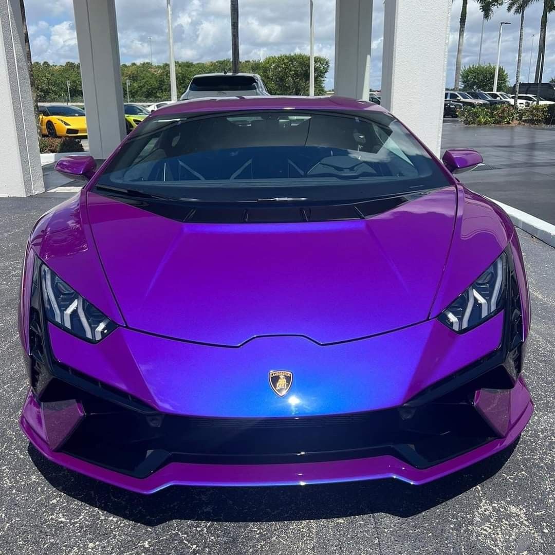 Purple Lamborghini Huracan sports car front view parked under cover