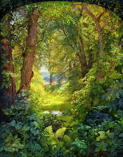 Sunlit forest path through dense green trees and lush undergrowth leading to a bright clearing