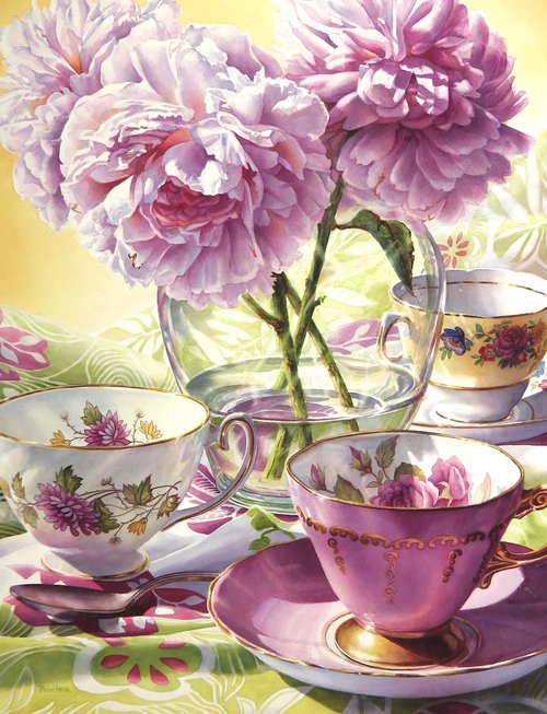 Pink peonies in glass vase with vintage teacups and saucers on floral tablecloth