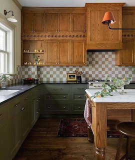 Traditional kitchen with oak upper cabinets, green lower cabinets, checkered backsplash, and wooden island