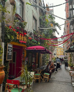 Colorful street in Lisbon with outdoor cafes, bunting, and historic buildings