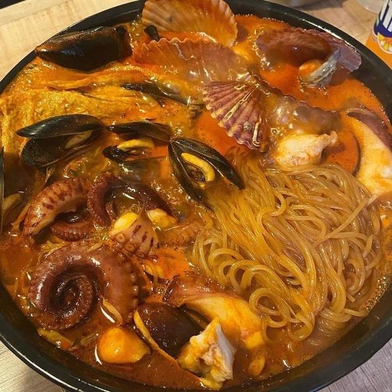 Korean seafood noodle soup with octopus, shrimp, mussels and noodles in spicy broth