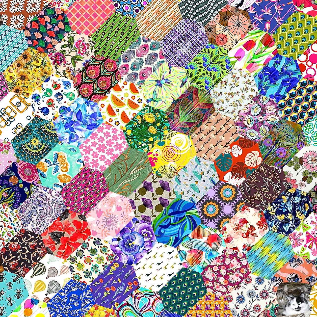 Vibrant patchwork quilt with varied fabric patterns including flowers, geometrics, and colorful designs