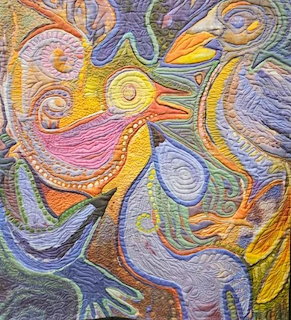 Colorful abstract quilt depicting stylized birds with swirling patterns in pink, yellow, blue, and orange
