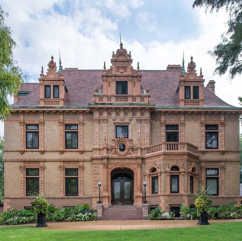Ornate historic mansion with Renaissance architecture and manicured lawn