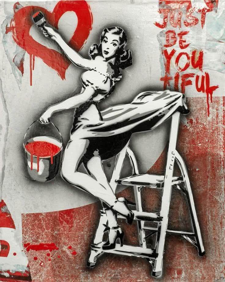 Stencil graffiti of pin-up woman on ladder painting a red heart with 'Just Be You Tiful' text