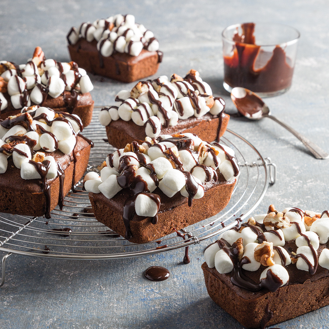 Chocolate brownies with marshmallows and chocolate drizzle on cooling rack