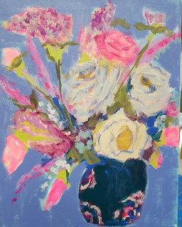 Impressionistic painting of pink and white flowers in a dark vase with colorful brushstrokes on blue background