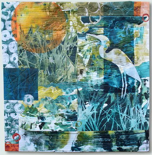 Abstract art quilt of a white egret in a blue-green marsh with reeds and layered textures