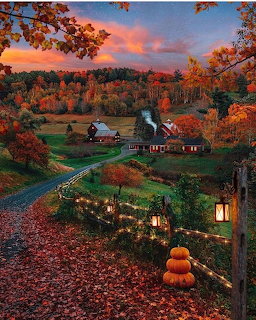 Autumn farm scene with barns, colorful fall trees, pumpkins, and glowing lanterns at sunset