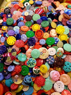Large collection of colorful vintage and modern buttons in various sizes, shapes, and designs