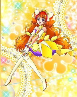Anime magical girl Cure Twinkle in yellow and orange costume with long orange hair and white boots