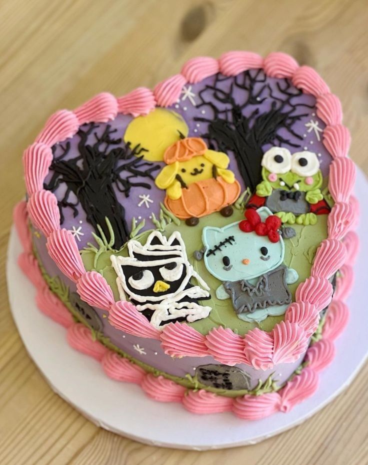 Heart-shaped cake with Sanrio characters in Halloween theme, pink frosting, on white plate