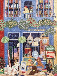 Painted antique shop storefront with striped awnings, flowers, and display windows full of vintage items