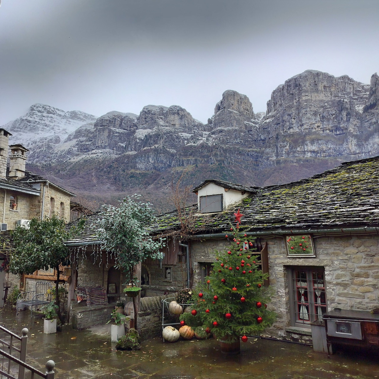 Stone cottage village with mountains and cloudy sky