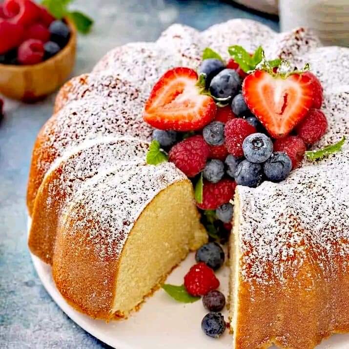 Bundt cake with powdered sugar and mixed berries on top