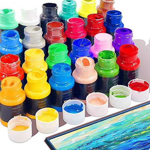 Colorful paint bottles with open caps and paint beside a canvas