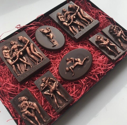 Dark chocolate pieces with metallic figure decorations in a red gift box