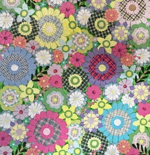 Colorful floral patchwork pattern with quilt-style daisies and rosettes