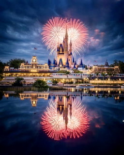 Cinderella Castle at twilight with pink fireworks and water reflection