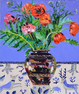 Colorful painting of flowers in ornate vase on blue patterned cloth