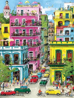 Colorful painted city buildings with balconies, cars, and people on a busy street