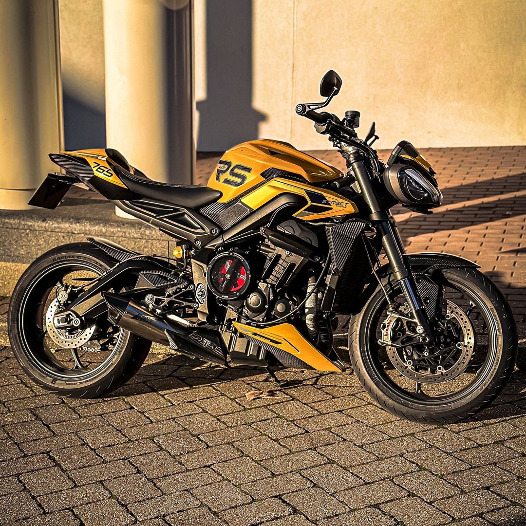 Yellow and black sport motorcycle parked on a paved surface outdoors