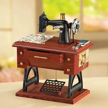 Miniature antique sewing machine model with dark wood cabinet and black metal mechanism
