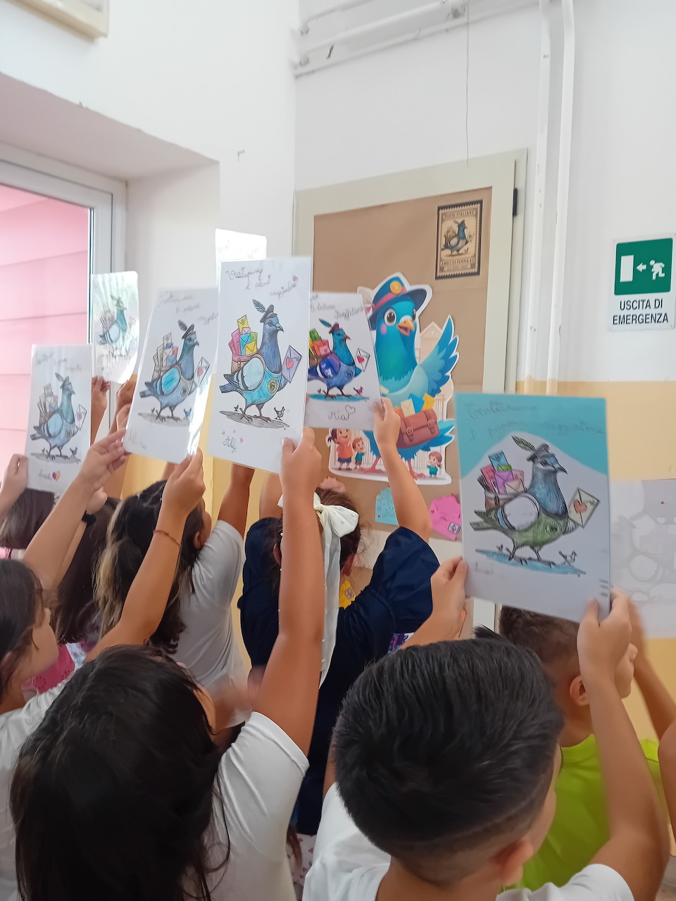 Children holding up illustrated cards with cartoon bird characters in a school hallway