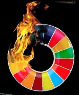 Colorful circular wheel with multicolored segments burning with flames on a black background