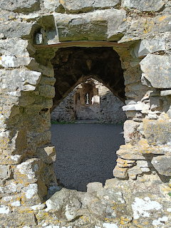 Stone opening framing an arched interior view of Carew Castle ruins