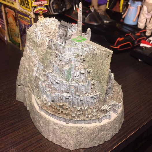 Detailed fantasy castle miniature on a rocky base displayed on a table indoors