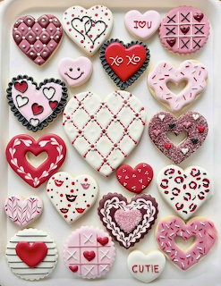 Assorted heart-shaped decorated sugar cookies with pink, red, and white Valentine's Day icing designs