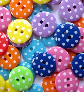 Colorful round buttons with white polka dots scattered together