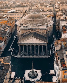 Aerial view of the Pantheon in Rome with its large dome and classical columns, plaza fountain in foreground