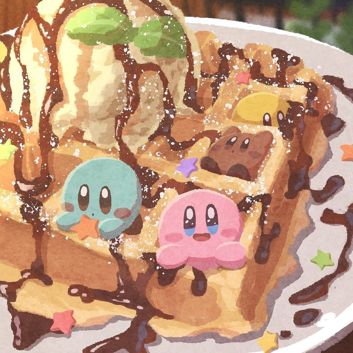 Pink and blue Kirby characters on waffles with ice cream, chocolate sauce, and star decorations