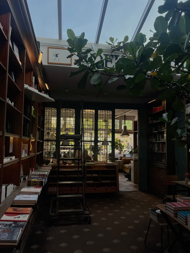 Cozy book cafe interior with bookshelves, tables, chairs, and large windows with plants