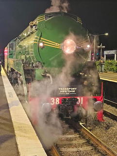 Green steam locomotive 3801 at Maitland station at night with smoke around the front