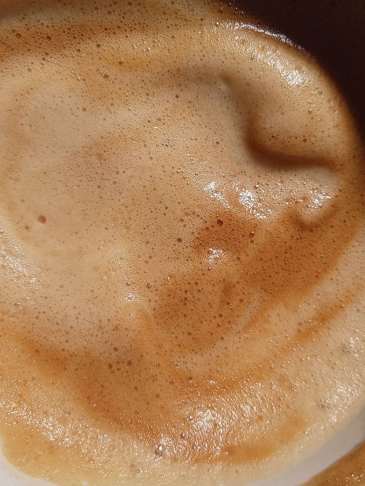 Close-up of frothy brown whipped coffee foam