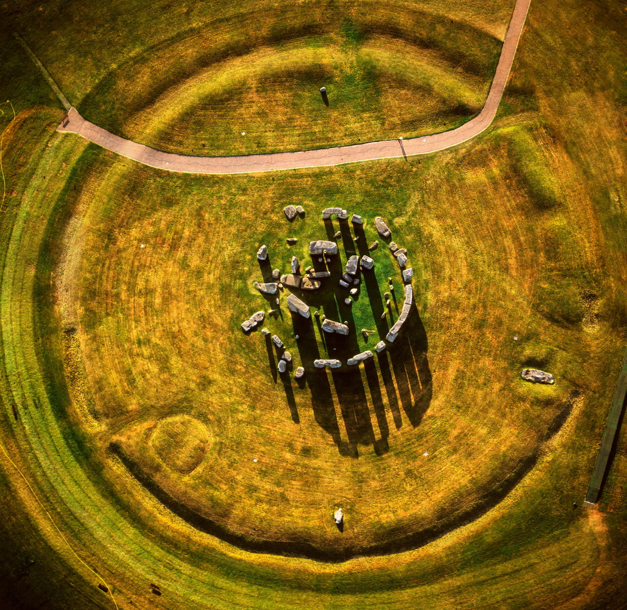 Aerial view of Stonehenge in a circular grassy field with surrounding paths