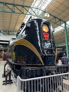 Pennsylvania Railroad GG1 electric locomotive 4935 on display inside a museum, black with gold pinstripes