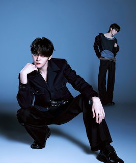 Young man in black outfit posed in a studio against a blue background, shown twice in the composition.