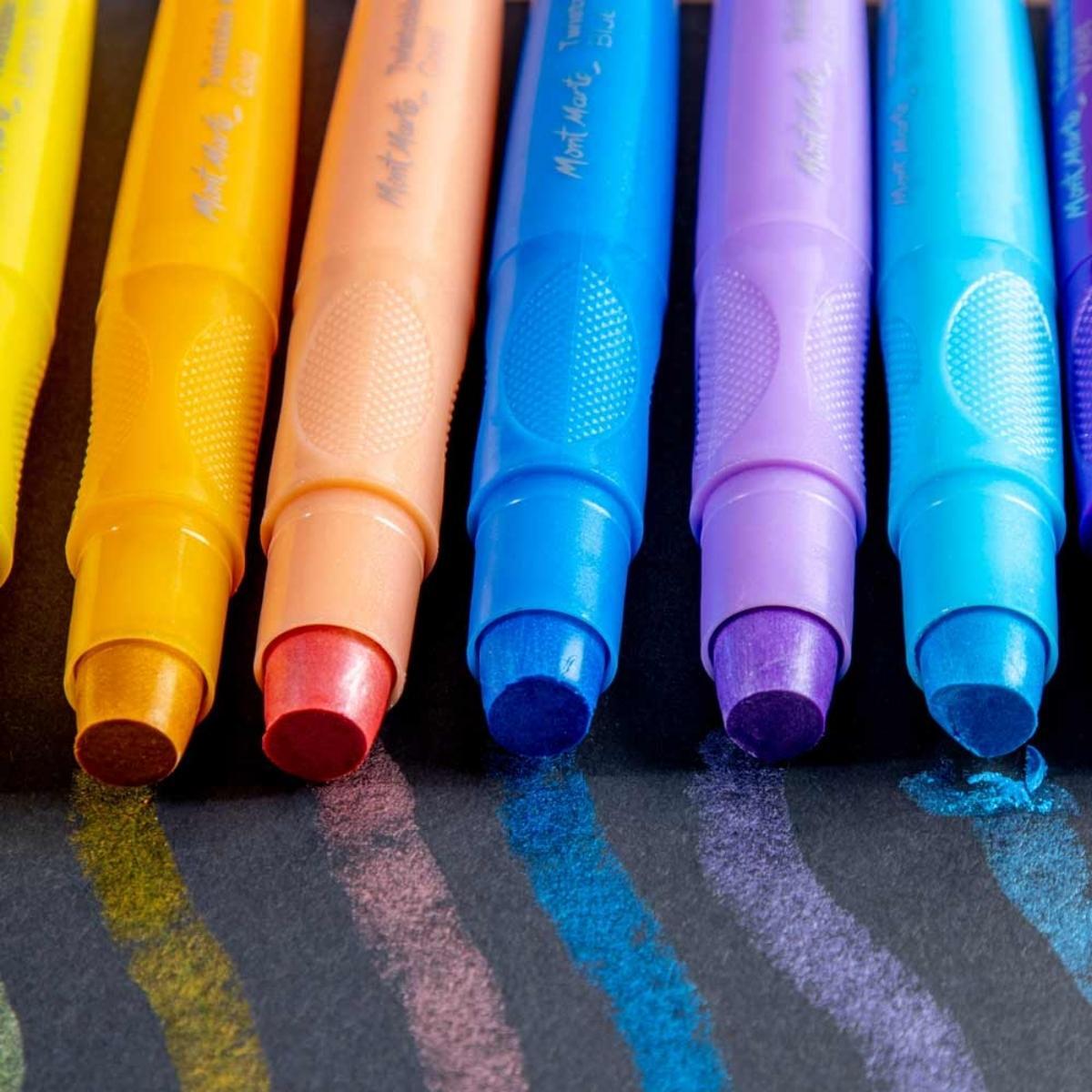 Five colorful marker pens on dark paper with matching color strokes