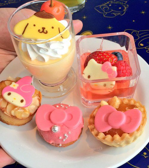 Plate of cute Sanrio character desserts with Pompompurin pudding, strawberry cake, and decorated cookies