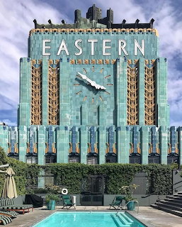 Turquoise Art Deco Eastern Columbia Building with golden ornaments and rooftop pool in Los Angeles