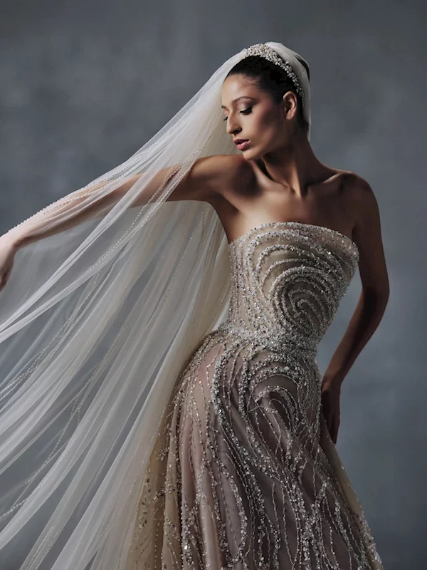 Bride in strapless gold beaded wedding dress with flowing veil and crystal tiara