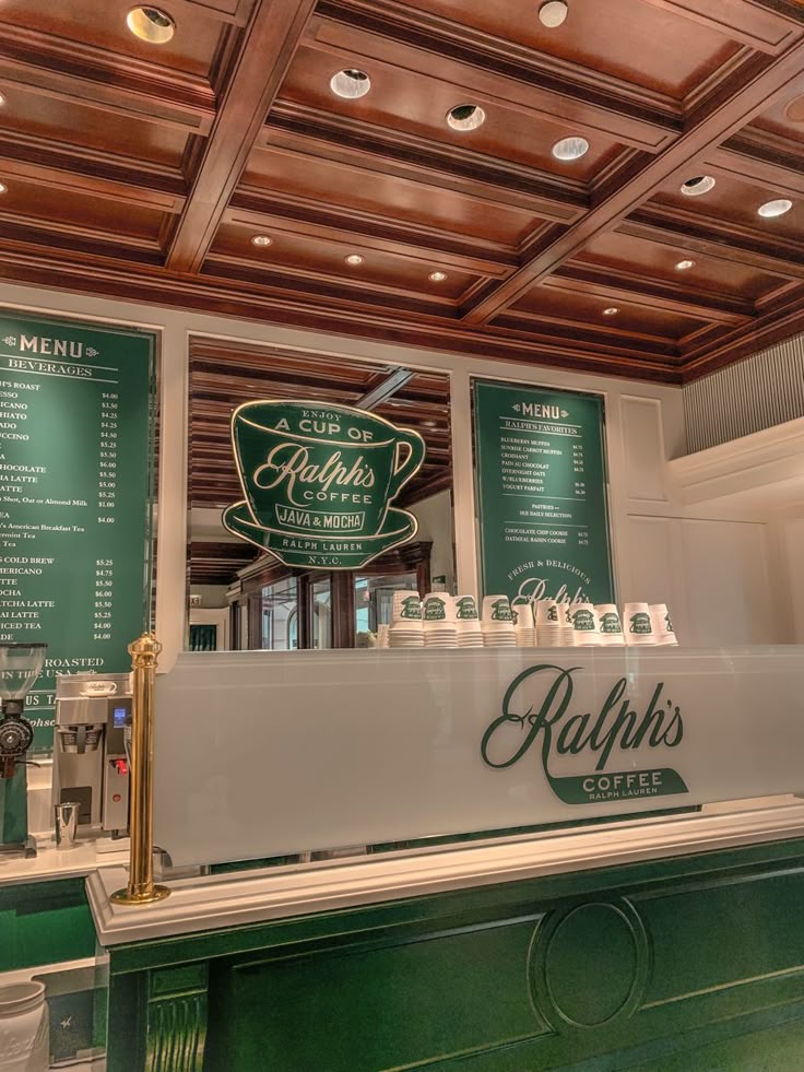 Ralph's Coffee cafe interior with white espresso machine, green walls and menu boards, wooden coffered ceiling