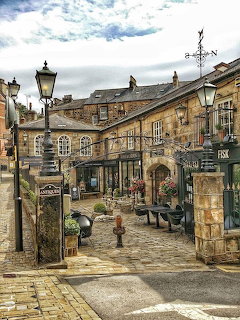 Historic cobblestone street with stone buildings and lamp posts in Harrogate, North Yorkshire