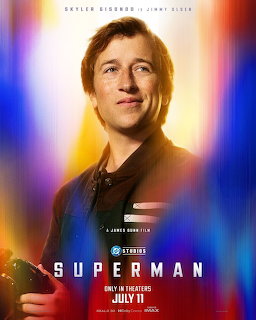 Man in dark jacket smiling against colorful blurred light background, Superman 2025 movie poster
