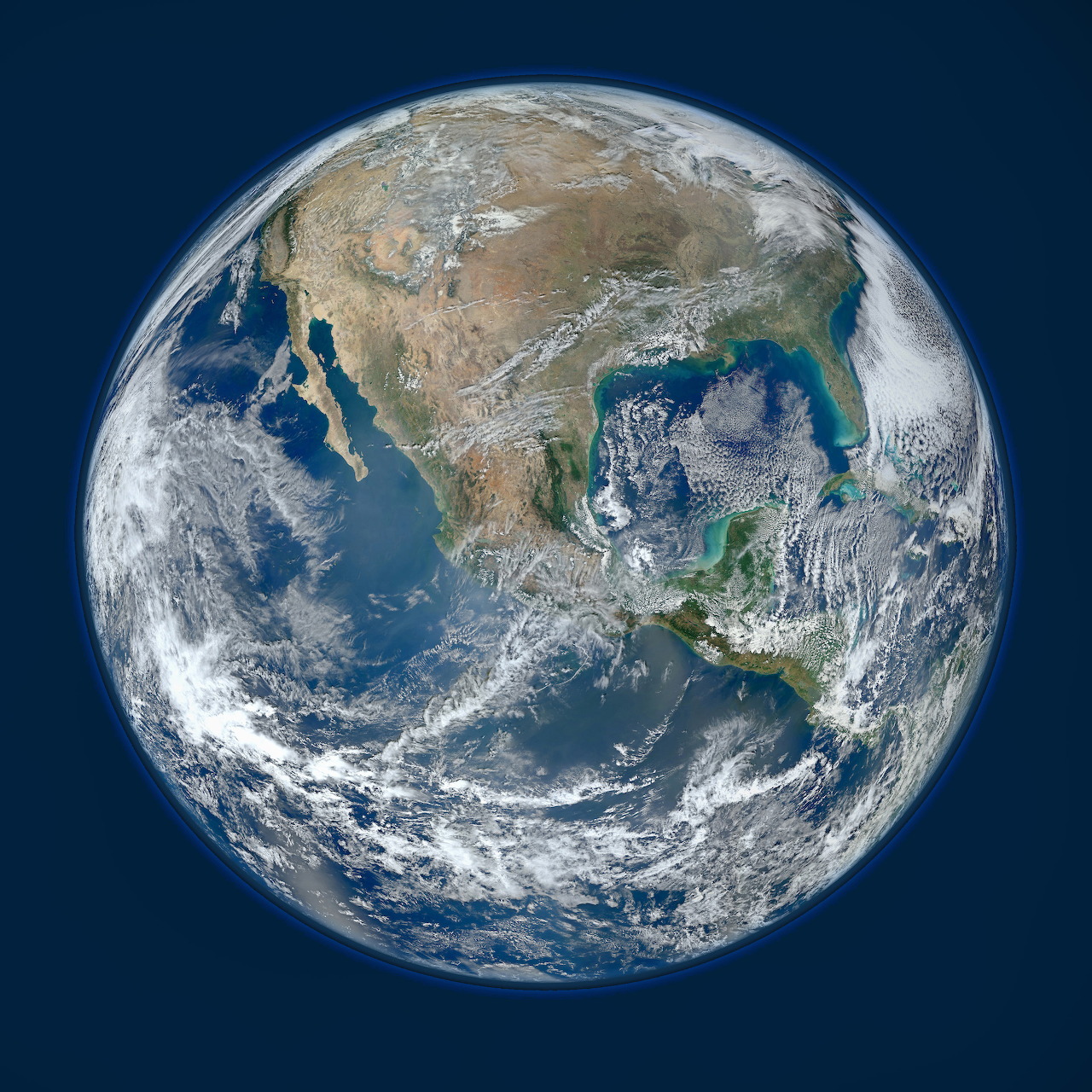Satellite photograph of Earth from space showing North America, swirling white clouds, and blue oceans